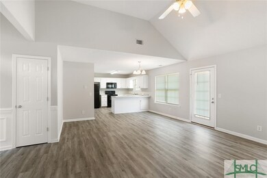 Large windows look out to the backyard and allow n
