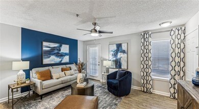 Living room featuring a textured ceiling, ceiling 