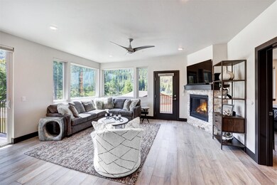 Living room with luxury wood-style flooring, a wea