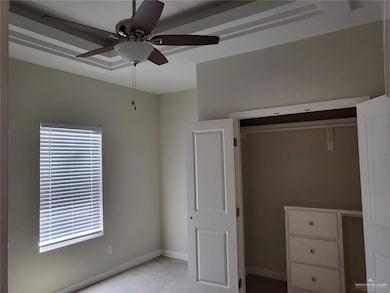 Unfurnished bedroom featuring baseboards, a closet, and multiple windows