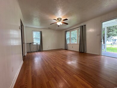 Spare room with wood-type flooring, a textured cei