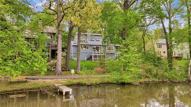 Back of property featuring a deck with water view