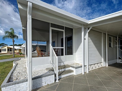 ENTER ONTO YOUR NEW FRONT LANAI OR ON THE SIDE UNDER CARPORT.