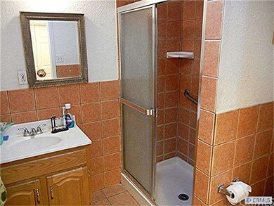 Beautiful tile bathroom is handicap accessible.