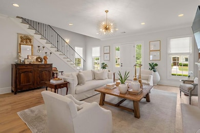 Delightful living room with custom iron stair railing.