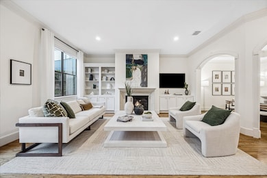 Large windows and arched openings create seamless flow throughout. A comfortable yet polished space—sure to become everyone’s favorite room in the home.