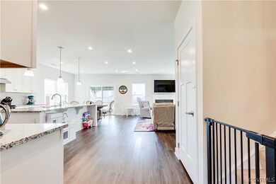 Kitchen featuring hanging light fixtures, backspla