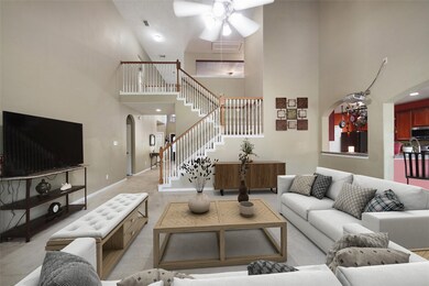This living room has a gas fireplace and high volu