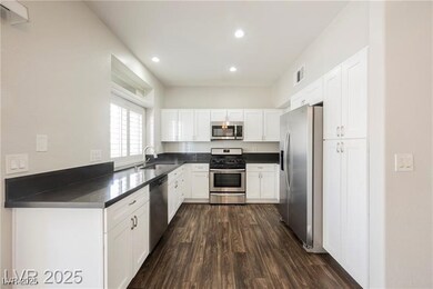 Kitchen featuring stainless steel appliances, dark