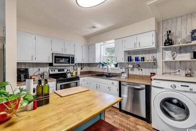Kitchen featuring white cabinets, appliances with 