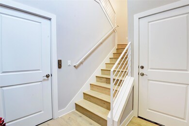 Staircase featuring wood finished floors