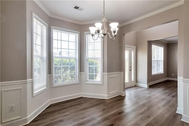 Unfurnished dining area featuring visible vents, c