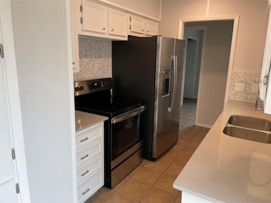 Kitchen featuring appliances with stainless steel