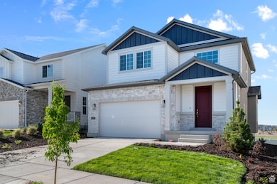 Craftsman inspired home with board and batten siding, concrete driveway, an attached garage, and stone siding
