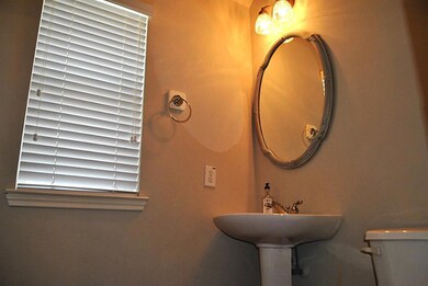 The half bath is located off the main hallway and provides convenient access to all living areas.  Great for guests!