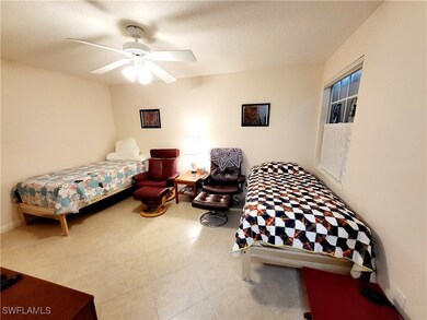 Bedroom with a textured ceiling and ceiling fan