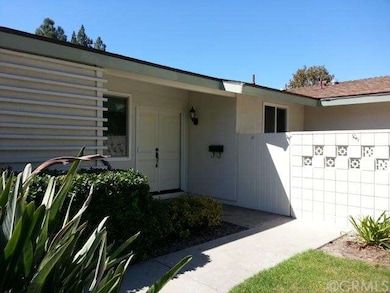 Front double door entry and walled-in courtyard.