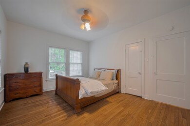 Bedroom has ceiling fan and lots of natural light.