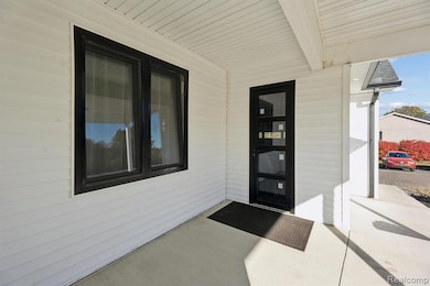 View of exterior entry with covered porch