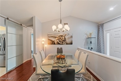 Dining area with an inviting chandelier, lofted ce