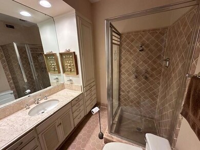Bathroom with vanity, toilet, and a shower with do