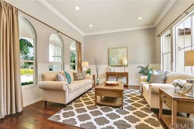 Formal Living Room with high ceiling, wainscoting and overlooks into the California Room and courtyard
