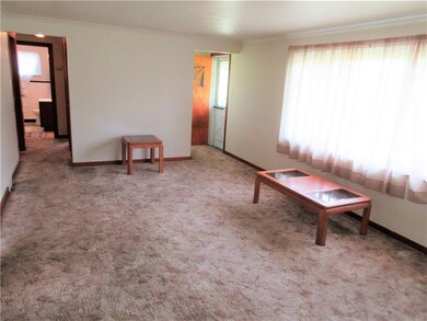 The spacious living room is enhanced with crown mo