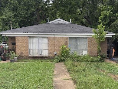 Ranch-style home with brick siding and a front lawn