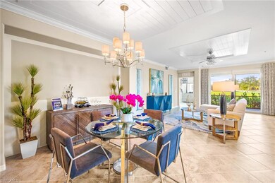 Dining area with light tile patterned floors, a notable chandelier, and ornamental molding