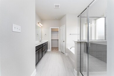 Primary bathroom with dual sinks, soaking tub and 