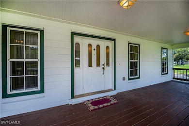 View of exterior entry with a porch