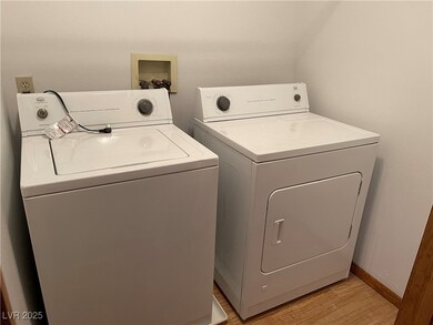 Washroom featuring washer and clothes dryer and li