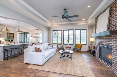 Spacious great room with a masonry fireplace and custom black plantation shutters