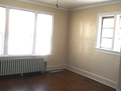 Front bedroom with hardwood floor and ceiling fan