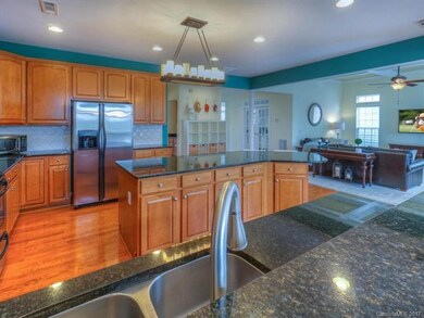 What a great Open Kitchen ~ Zoom in and check out the size of this island with bar seating, beautiful granite and stunning patterned tile backsplash!