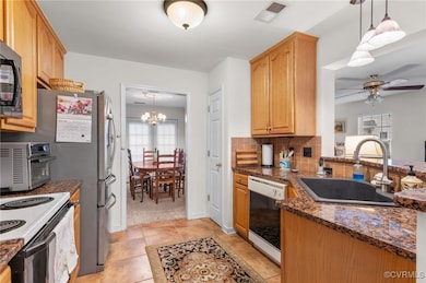 Kitchen featuring dishwasher, a sink, visible vent