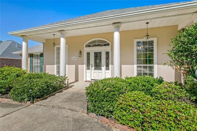 Front view of home with rounded columns along fron
