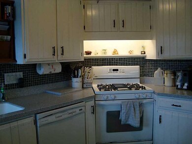 Kitchen. The tiled back splash and solid surface c