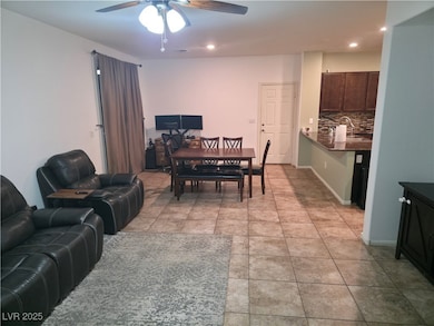 Dining space featuring a ceiling fan, recessed lighting, and light tile patterned floors