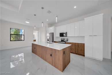 Kitchen with stainless steel appliances, modern ca