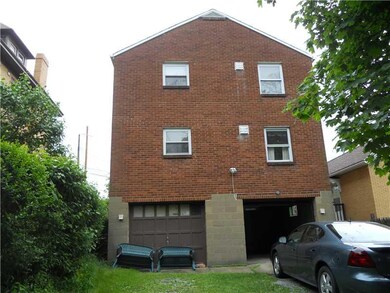 Exterior Back. Each unit has a one car garage.  Th
