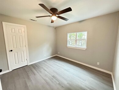 Empty room featuring ceiling fan and wood-type flo