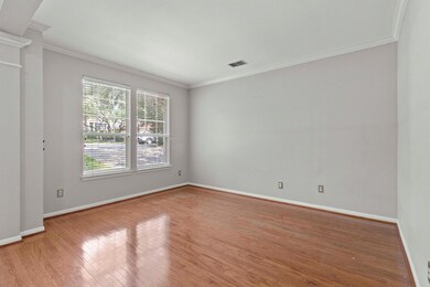 Unfurnished room featuring crown molding and wood finished floors