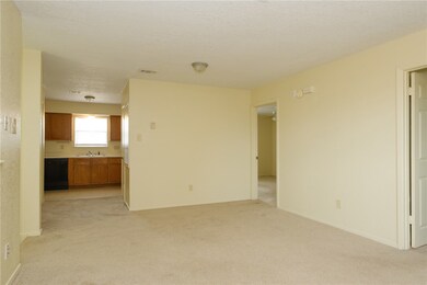 Unfurnished living room with light carpet, visible