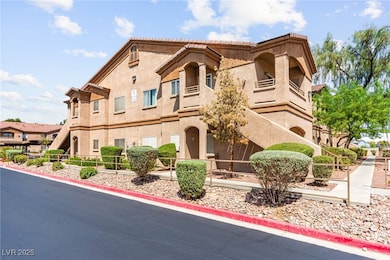 View of front of home featuring stucco siding and a balcony