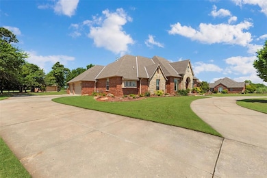 View of front of home with curved driveway, brick siding, and a front yard