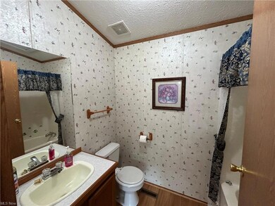 Bathroom featuring vanity with extensive cabinet s