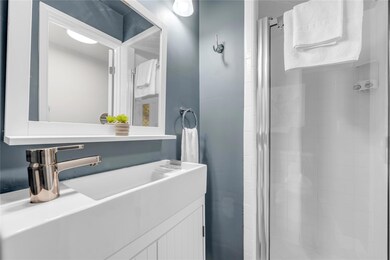 Bathroom featuring a shower stall and vanity