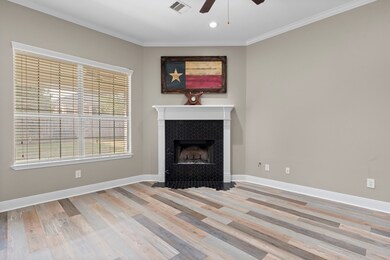 The heart of this inviting Family Room, the stately corner wood-burning fireplace—framed in tasteful hexagon tile and topped with a classic wood mantle—adds warmth and sophistication. Designed for function and comfort, this room also features a spacious wall with cable hookups—perfect for additional electronics or shelving for your favorite collectibles.