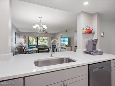 Kitchen with a sink, pendant lighting, stainless s